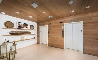 a room with wooden walls and a white door at Champagne at Tiffany's - Luxury Condo by the Beach in Fort Lauderdale