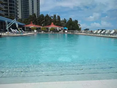 a large pool of blue water with buildings in the background at Estudios en las playa de Sunny Isles Beach in Sunny Isles Beach