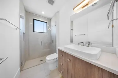 a bathroom with a sink and a toilet and a shower at LVS Villa Blanco 5BR Coastal Oasis with Rooftop Sunset Deck Heated Pool Spa & Walk-to-Beach Access in Fort Lauderdale