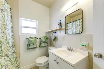 a bathroom with a sink and a toilet and a mirror at 3 Mi to Beach Pet-Friendly Gem in Hollywood in Hollywood
