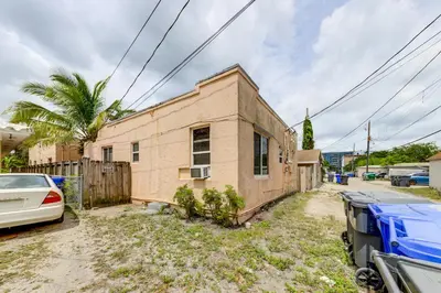 a brick house with cars parked in front of it at 3 Mi to Beach Pet-Friendly Gem in Hollywood in Hollywood