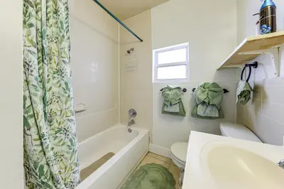a bathroom with a tub and a toilet and a sink at 3 Mi to Beach Pet-Friendly Gem in Hollywood in Hollywood