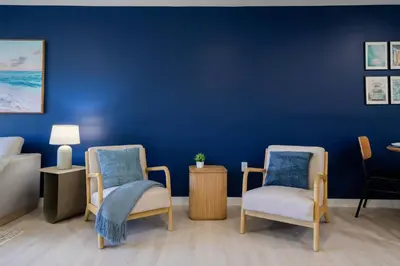 a room with two chairs and a blue wall at New Spacious 3BR Apt With Rooftop Pool 2 Parking in Hollywood