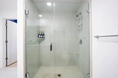 a shower with a glass door in a bathroom at New Spacious 3BR Apt With Rooftop Pool 2 Parking in Hollywood