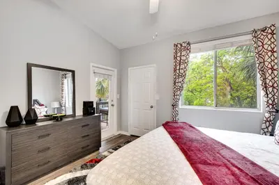 a bedroom with a large bed and a large window at 2 Br 2 Bath Waterfront Apt Walking To Beach in Hallandale Beach