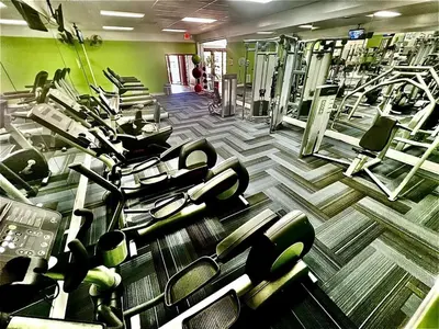 a gym with a bunch of tread machines in it at 2 Br 2 Bath Waterfront Apt Walking To Beach in Hallandale Beach