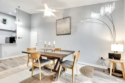 a dining room with a wooden table and chairs at 2 Br 2 Bath Waterfront Apt Walking To Beach in Hallandale Beach