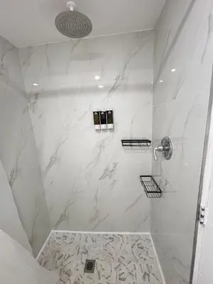 a bathroom with a shower with white marble at Miami City Escape in Hialeah