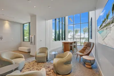 a living room with chairs and a table and windows at New 1Bed 1 bath Ocean view in Miami Beach
