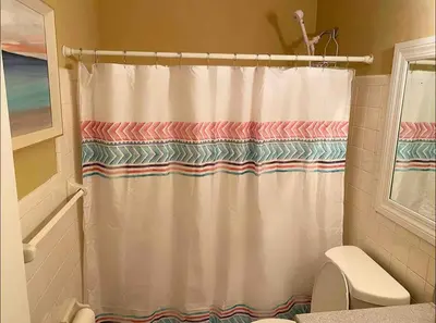 a bathroom with a shower curtain and a toilet at Lovely 2 Bedroom Condo With Free Parking & Wifi!! in Sunrise
