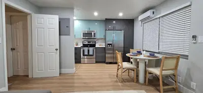 a kitchen with a table and chairs and a kitchen with a stove at Aquamarina in Fort Lauderdale
