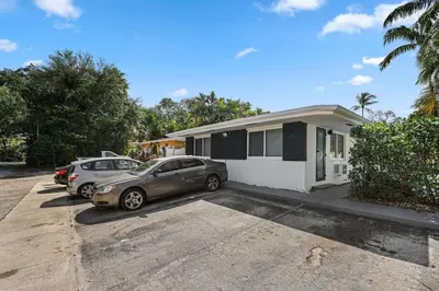 a house with two cars parked in a parking lot at Aquamarina in Fort Lauderdale