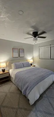 a bedroom with a bed with a ceiling fan at Aquamarina in Fort Lauderdale