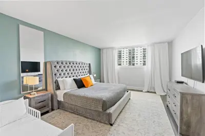a bedroom with a bed and a television in it at SUNNY ISLES 4BR Pool & Beach Access in Sunny Isles Beach