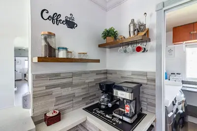 a kitchen with a coffee machine on a counter at Waterfront 3BR with Pool Tiki Hut & Mini Golf in Miami Gardens