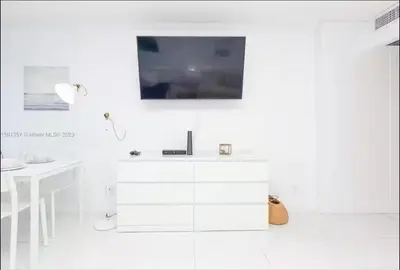a white bathroom with a sink and a desk at UNIT #1108 Castle Beach Club Condominium in Miami Beach