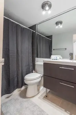 a bathroom with a toilet and a sink and a shower at UNIT #1108 Castle Beach Club Condominium in Miami Beach