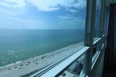 a view of a beach from a window at Oceanview Studio at Castle Beach Club – Pool, Beach Access, Valet Parking, Gym & More! in Miami Beach
