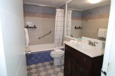 a bathroom with a toilet and a sink and a shower at Oceanview Studio at Castle Beach Club – Pool, Beach Access, Valet Parking, Gym & More! in Miami Beach