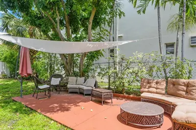 a patio with a couch and chairs and a table at Soleado Hotel in Fort Lauderdale