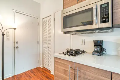 a kitchen with a microwave and a stove at So South Beach in Miami Beach