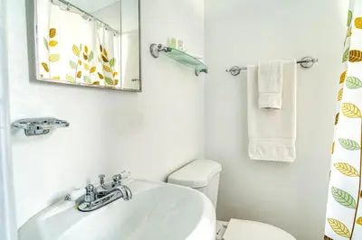 a bathroom with a sink and a mirror and a toilet at So South Beach in Miami Beach