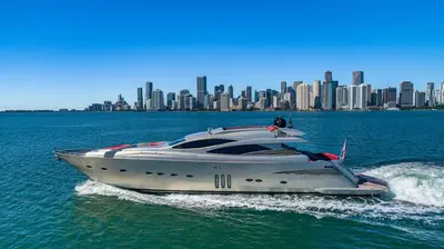 a white boat in the water with a city at New Luxury Beachfront Condo with Rooftop Pool in Hollywood