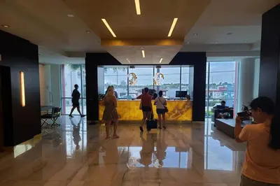 a group of people standing in a lobby at New Luxury Beachfront Condo with Rooftop Pool in Hollywood
