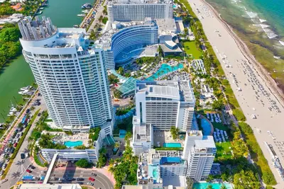 an aerial view of a city with a beach and buildings at Luxury Oceanview Suite at the Fontainebleau Miami Beach with Balcony, King & Sofa Bed in Miami Beach
