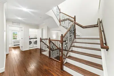 a staircase in a home with white walls and wooden floors at Lux Home with Rooftop & Elevator 2mi to Beach in Fort Lauderdale