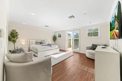 a white bedroom with a bed and a couch at Lux Home with Rooftop & Elevator 2mi to Beach in Fort Lauderdale