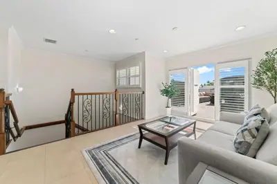 a living room with a couch and a glass table at Lux Home with Rooftop & Elevator 2mi to Beach in Fort Lauderdale