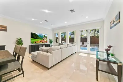 a living room with a couch and a table at Lux Home with Rooftop & Elevator 2mi to Beach in Fort Lauderdale