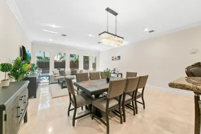 a dining room and living room with a table and chairs at Lux Home with Rooftop & Elevator 2mi to Beach in Fort Lauderdale