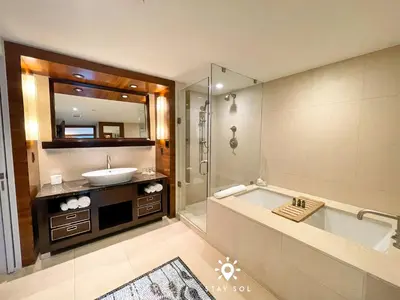 a bathroom with a tub and a sink and a mirror at Spectacular 1-Bedroom Sea View Luxury & Comfort in Miami Beach