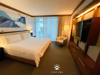 a hotel room with a bed and a flat screen tv at Spectacular 1-Bedroom Sea View Luxury & Comfort in Miami Beach