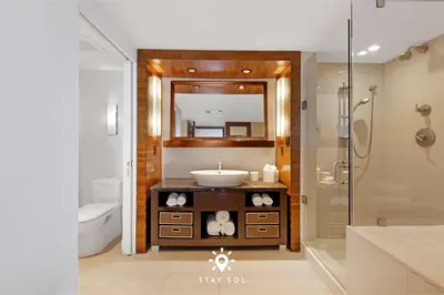 a bathroom with a sink and a mirror at Spectacular 1-Bedroom Apartment Beach view in Miami Beach