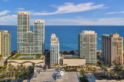 an aerial view of a city with tall buildings and the ocean at Spectacular 1-Bedroom Apartment Beach view in Miami Beach