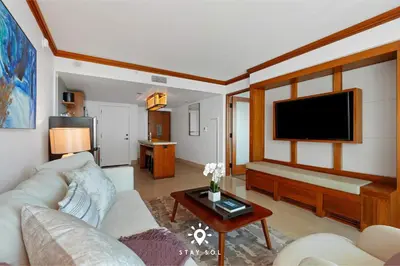 a living room with a couch and a flat screen tv at Spectacular 1-Bedroom Apartment Beach view in Miami Beach