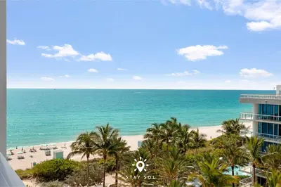 a view of the beach from the balcony of a resort at Spectacular 1-Bedroom Apartment Beach view in Miami Beach
