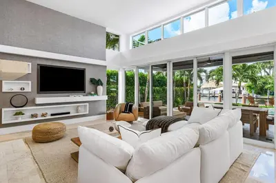 a living room with white furniture and a tv at Riviera Reserve by Stay Awhile Villas in Fort Lauderdale
