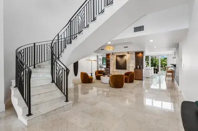 a staircase in a house with a living room at Riviera Reserve by Stay Awhile Villas in Fort Lauderdale