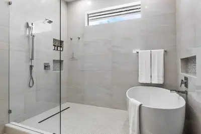 a white bathroom with a tub and a shower at Riviera Reserve by Stay Awhile Villas in Fort Lauderdale