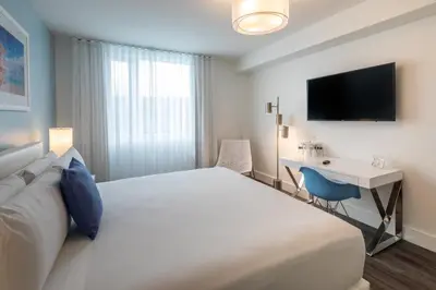 a hotel room with a bed and a desk at President Hotel Villa in Miami Beach