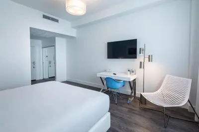 a hotel room with a bed and a desk at President Hotel Villa in Miami Beach