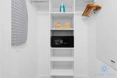 a white shelf with a microwave in a room at Stylish 2BR High-Rise Retreat w Ocean Views in Hallandale Beach