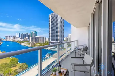 a balcony with chairs and a view of the city at Stylish 2BR High-Rise Retreat w Ocean Views in Hallandale Beach