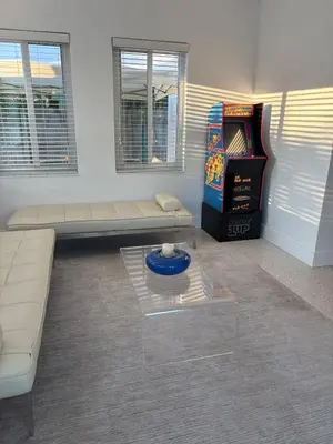 a living room with a couch and a video game at Mid-Century with Outdoor Oasis in Fort Lauderdale