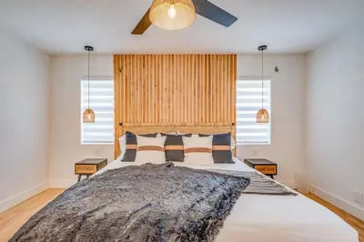 a bedroom with a large bed and two windows at Fox Garden Luxury Boho Near Downtown & Beach home in Fort Lauderdale