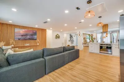 a living room with a couch and a kitchen at Fox Garden Luxury Boho Near Downtown & Beach home in Fort Lauderdale